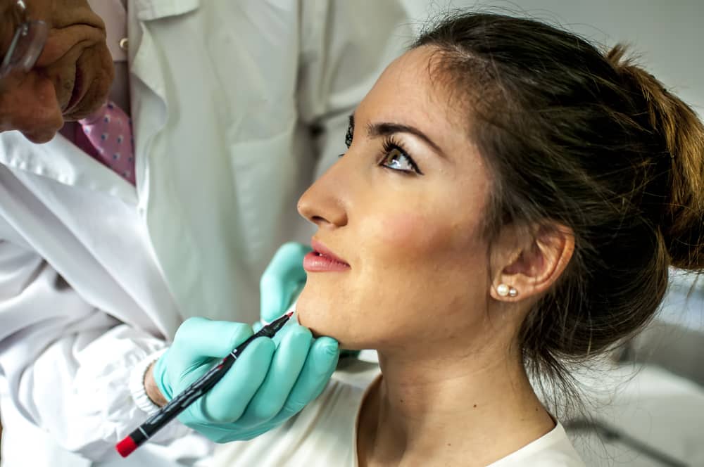 doctor looking at her face